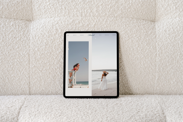 A tablet displaying two photos side by side rests on a textured, cream-colored fabric surface—perfect inspiration for your next Showit template. One image features a woman on a lifeguard stand; the other shows her in a white dress by the ocean.